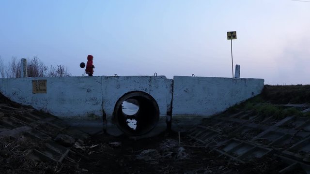Bridge child in a respirator red jacket with a toy and a black ball, fear and apocarypse, radiation hopelessness