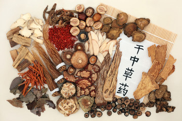 Chinese herbal medicine with calligraphy script on rice paper, bamboo and cream background....
