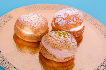 Custard cakes with cream on a blue background