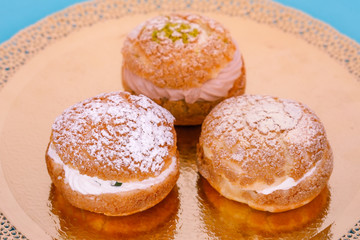 Obraz na płótnie Canvas Custard cakes with cream on a blue background