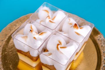 Tasty souffle desserts in a square glass on a blue background