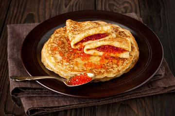 Russian pancakes - blini with red  caviar. Selective focus