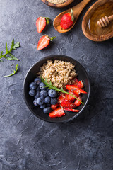 Healthy vegan diet salad quinoa with blueberry,strawberry, honey and chia seeds. Concept sooper food  eating breakfast. Top view