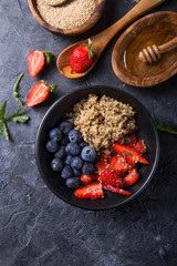 Healthy vegan diet salad quinoa with blueberry,strawberry, honey and chia seeds. Concept sooper food  eating breakfast. Top view