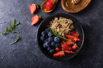 Healthy vegan diet salad quinoa with blueberry,strawberry, honey and chia seeds. Concept sooper food  eating breakfast. Top view