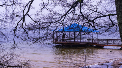 Winter holiday concept. Gazebo on the winter lake.