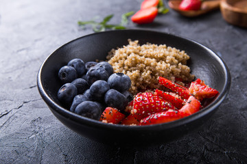 Healthy vegan diet salad quinoa with blueberry,strawberry, honey and chia seeds. Concept sooper food  eating breakfast. Top view