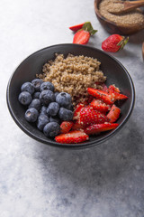 Healthy vegan diet salad quinoa with blueberry,strawberry, honey and chia seeds. Concept sooper food  eating breakfast. Top view