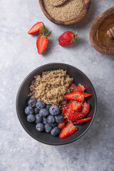 Healthy vegan diet salad quinoa with blueberry,strawberry, honey and chia seeds. Concept sooper food  eating breakfast. Top view