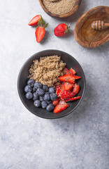 Healthy vegan diet salad quinoa with blueberry,strawberry, honey and chia seeds. Concept sooper food  eating breakfast. Top view