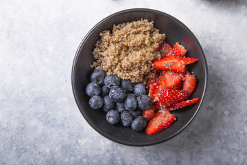 Healthy vegan diet salad quinoa with blueberry,strawberry, honey and chia seeds. Concept sooper food  eating breakfast. Top view