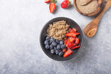 Healthy vegan diet salad quinoa with blueberry,strawberry, honey and chia seeds. Concept sooper food  eating breakfast. Top view