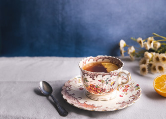 Elegant floral vintage tea cup with tea and lemon slice