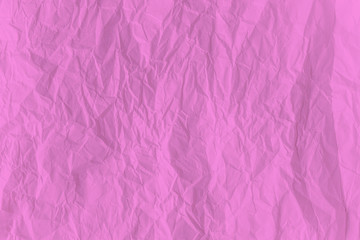 Pink crumpled paper close up texture background