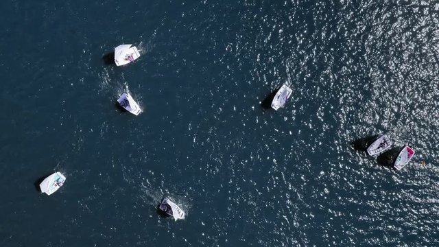 Top down view of regatta of small boats on lake