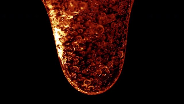 Colored mucus flowing from top to bottom on the dark background