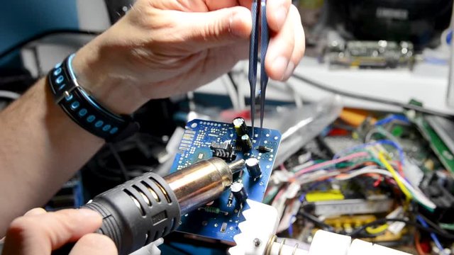 Technical support worker drops the fee PCB. Soldering iron