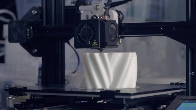 The 3D printer prints the model out of white plastic. Modern techology. 4K HD. with sound