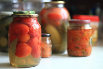 Fototapeta na wymiar jars of pickles tomatoes and cucumbers