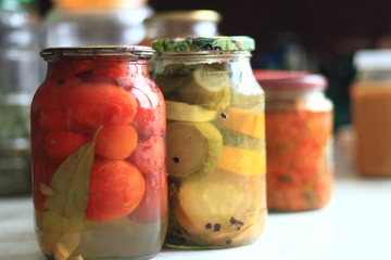jars of pickles tomatoes and cucumbers