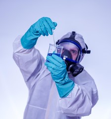 male lab technician doing research in the lab. with gas mask. coronavirus