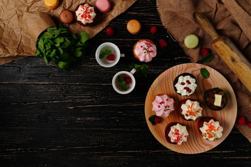 Tasty cakes on the black background