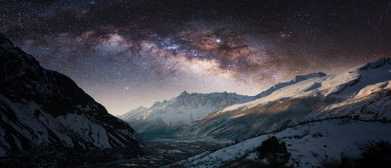 Milky Way above snowy mountains. Sky with stars at night in Nepal, Himalayas.