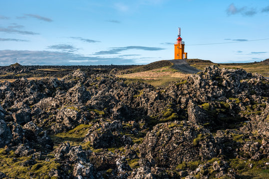 Hopsnes Lighthouse surrounded by lava field, Grindavik, Reykjanes Peninsula, Iceland