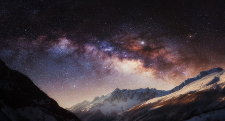 Panorama of night sky full of stars with colorful Milky Way in the mountain. Nepal, Himalayas.