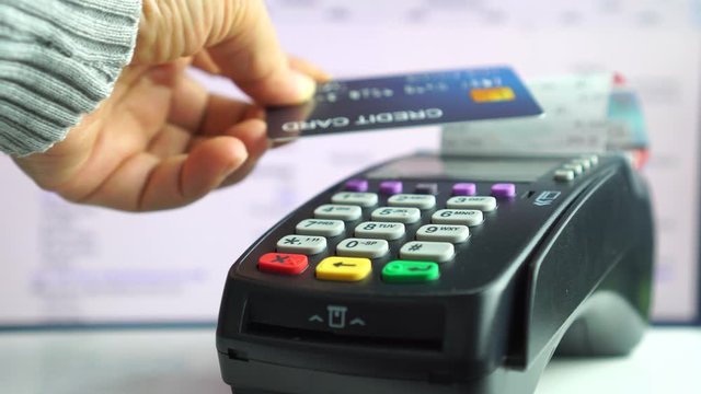 Customer using credit cards (mock up) scan nfc for payment to owner at counter store,  making pay through nfc technology, paying with contact less card for business service trade concept