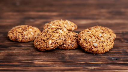Pile of oatmeal cookies on a dark wooden table_
