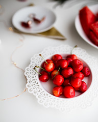 Cherries on plate. White stylish background. Summer fruit. Healthy lifestyle, clean eating concept.