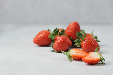 Berries of ripe strawberries on a light surface.  Close-up.  Free space for text.