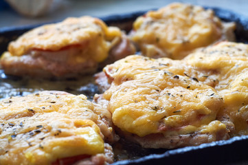 chicken fillet baked in the oven with cheese and tomatoes