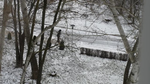 Janitor removes snow in the city, snowstorm, snowdrifts