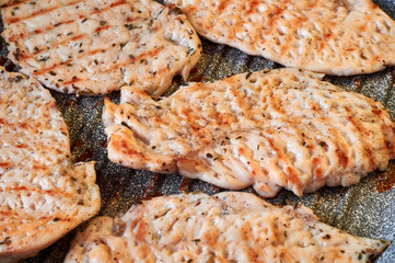 chicken fillet chop is fried on a grill pan