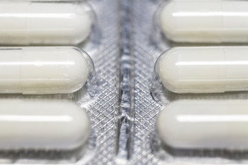 Medicinal drug pills capsules in blister close-up. Macro photo