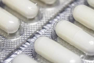 Medicinal drug pills capsules in blister close-up. Macro photo