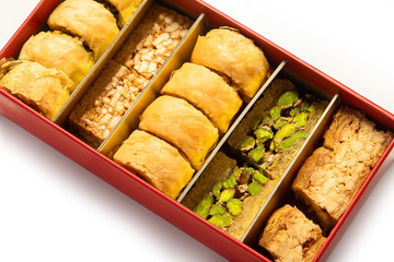 Eastern sweets. Baklava in a red box on a white background.