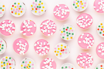 Colorful cupcakes on a white background.