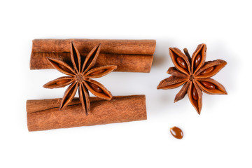 Anise star spice with seeds and two cinnamon sticks. Close-up macro isolated on white background. Top view, flat lay,