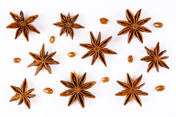 Anise star. Some star anise fruits with seeds. Close-up on white background with shadows, flat lay view of chinese badiane spice or Illicium verum.