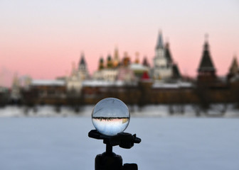 winter frosty morning with a view of the lake and the ancient fortress through a crystal ball