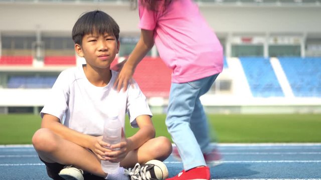 Slow motion ??Young Asian boy get a bootle of water from little girl