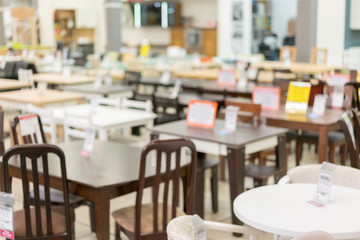 Furniture store. Sale of tables and chairs. Blurry.