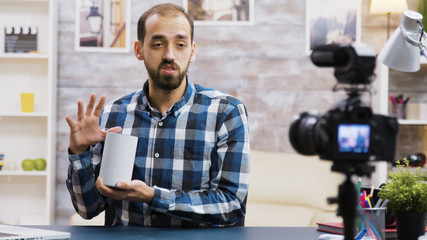 Fototapeta premium Famous vlogger filming smart speaker review for his followers