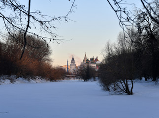winter frosty morning with a view of the lake and the ancient fortress