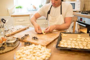 Young man bakes cookies