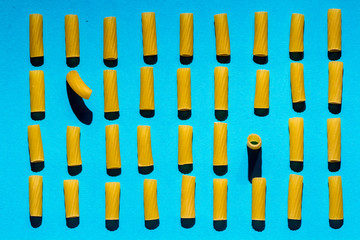 Italian pasta arranged in rows on a blue background