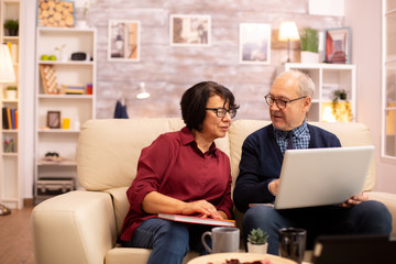 Grandmother and grandfather using a laptop to chat with their grandsons